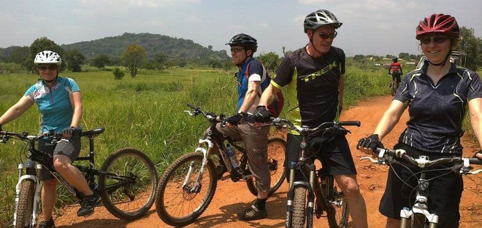 A group of cyclists taking a short break after riding through the countryside Sigiriya, Sri Lanka.